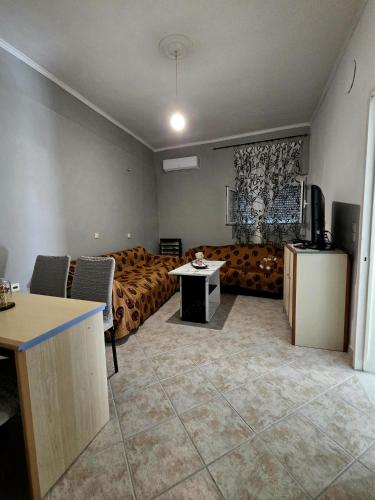 a living room with a couch and a table at Chora Residence in Khóra