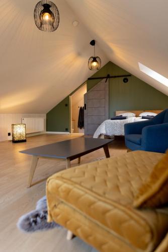 a living room with a couch and a bed at Lendle Peace & Wellness Stay Märjamaa in Märjamaa