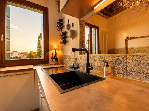 a kitchen with a sink and a window at Villa Venezia Apartment in Dolo