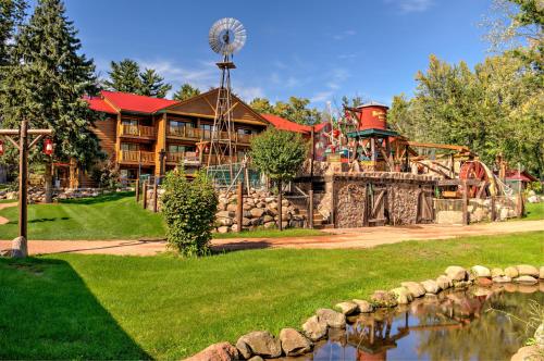a playground in front of a house with a water park at Meadowbrook Resort in Wisconsin Dells