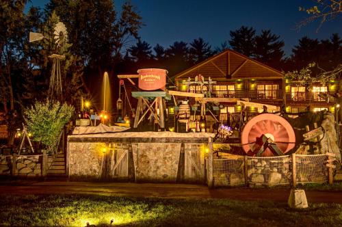 a building with a water fountain at night at Meadowbrook Resort in Wisconsin Dells