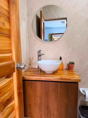 a bathroom with a sink and a mirror at El Gran Jeronimo Hostal Rincon del Mar in Rincón