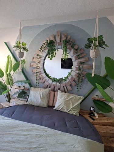 a bedroom with a bed with a mirror and plants at Jungle Dream in Hitzkirch