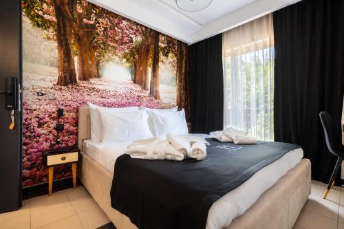 a bedroom with two towels on a bed at Pollock Hotel, Ribarska Banja in Ribarska Banja
