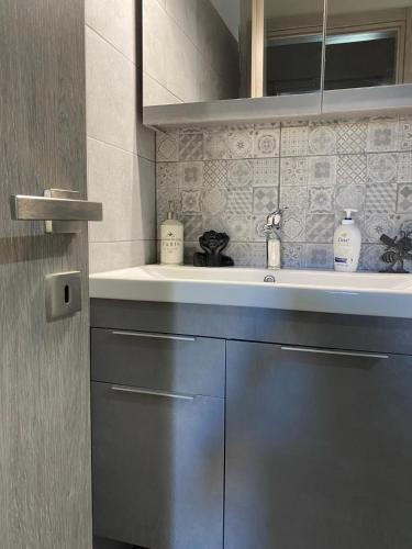 a bathroom with a sink and a counter top at Villa J&C-SAINT AIMILIANOS in Porto Heli