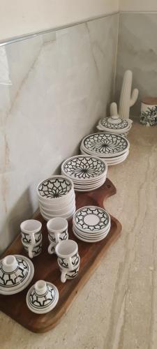 a group of white and black dishes on a shelf at Villa Nour Kélibia in Kelibia
