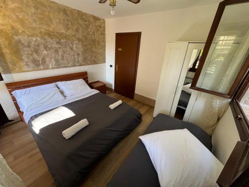 a bedroom with a bed with two towels on it at venice private rooms in Venice