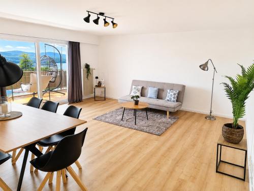 a living room with a couch and a table at Bright Lake-View Apartment in Montreux