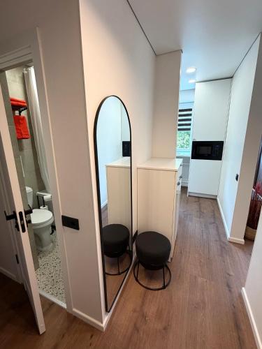 a bathroom with two chairs and a mirror at AC Central Station apartments in Daugavpils