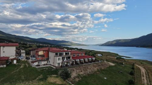 an aerial view of a house next to a body of water at Complex Forest Sarnitsa in Sarnitsa