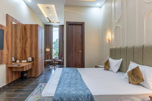 a hotel room with a bed and a desk at Velmora Stay Premium Luxury Villa with Private Pool in Amritsar