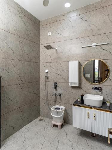 a bathroom with a sink and a toilet at Velmora Stay Premium Luxury Villa with Private Pool in Amritsar