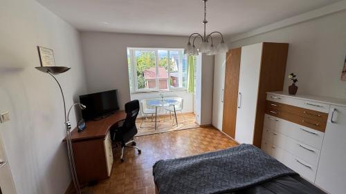 a bedroom with a desk and a bed and a table at Nice Studio Apartment in Gumpoldskirchen