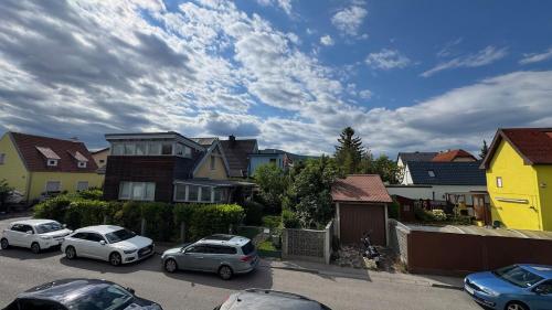 a group of cars parked in a parking lot with houses at Nice Studio Apartment in Gumpoldskirchen