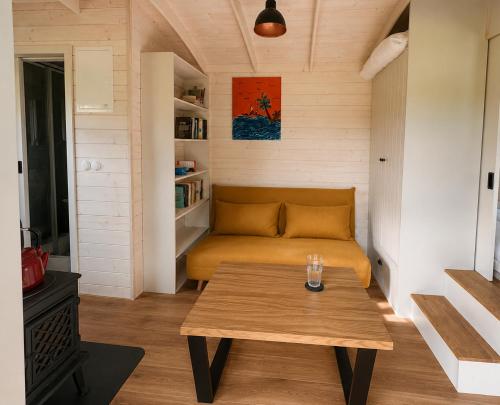 a living room with a couch and a table at maringotka Hedvika glamping in Pašice