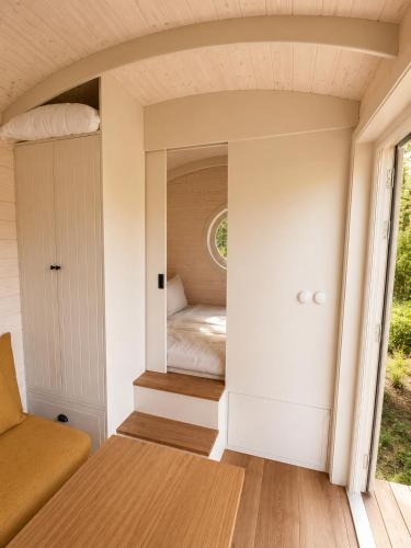 a small bedroom in a tiny house at maringotka Hedvika glamping in Pašice