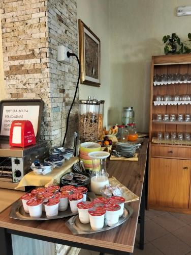 a table with cupcakes and other food on it at Albergo Rosa & Cosetta in Casal Borsetti