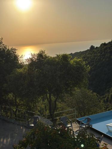 a view of the sun setting over the water at Fannoun Getaway Lodge by Hansa in Ḩayy al Qal‘ah