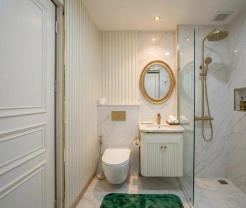 a bathroom with a shower and a toilet and a sink at Kanchanaburi Residence Hotel in Kanchanaburi City