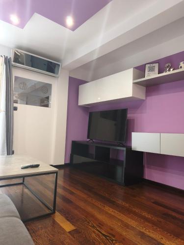 a living room with a couch and a tv at Apartman Brzović in Omiš