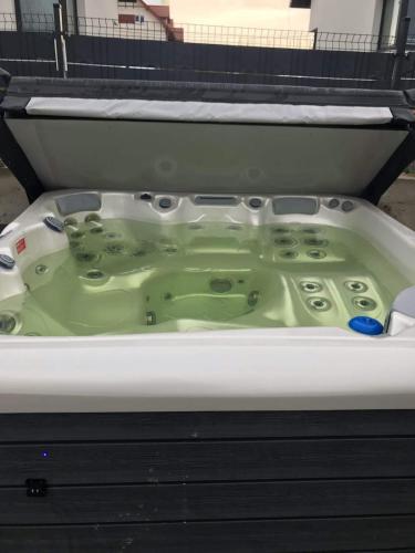 a bath tub filled with a green liquid at Lipove Spa in Lipowe