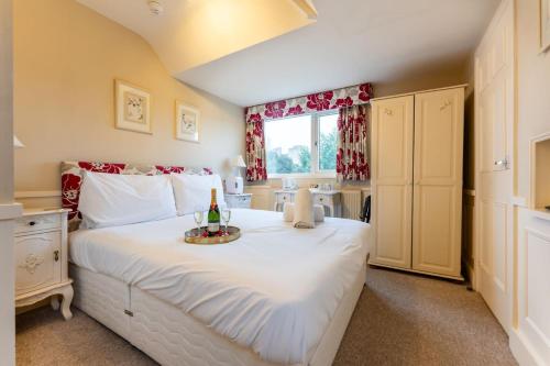 a bedroom with a large white bed with a tray on it at Cransley in Bournemouth