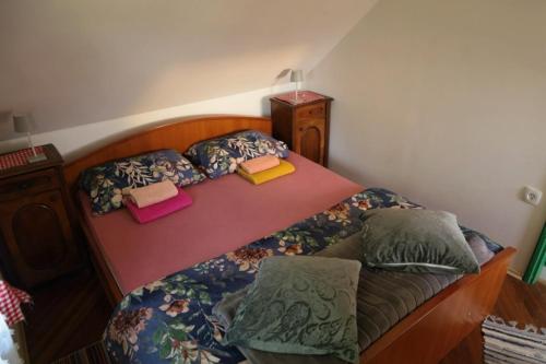 a bedroom with a bed with two pillows on it at Jurina Hiža in Beletinec