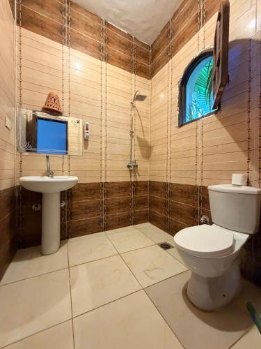 a bathroom with a toilet and a sink at Palm Valley camp in Nuweiba‘ el Muzeinah