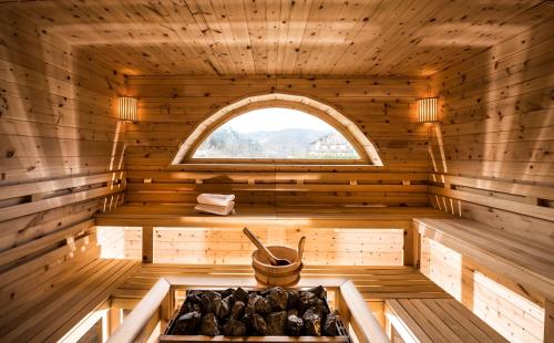 an inside of a sauna with a window at Gartenhotel Völser Hof - Adults Only in Fiè