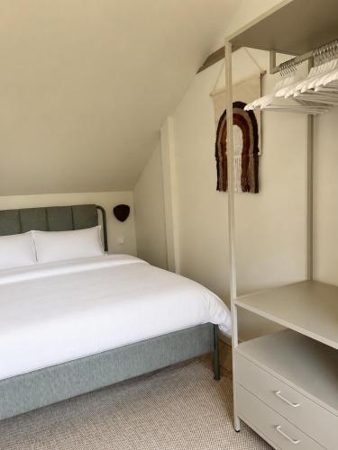 a bedroom with a bed and a book shelf at De Kustwacht in Warmenhuizen