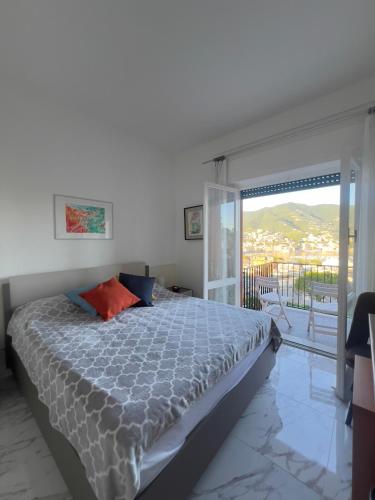 a bedroom with a bed and a sliding glass door at Eurotel 406 in Rapallo