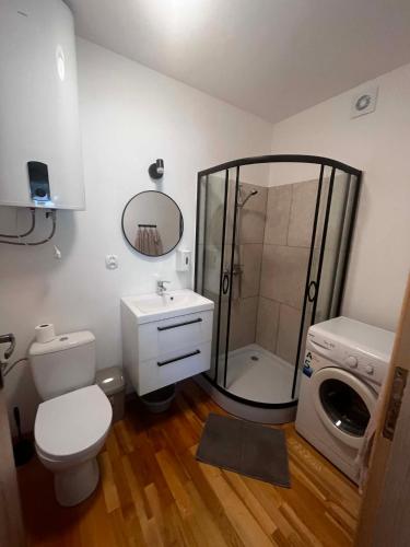 a bathroom with a shower and a toilet and a sink at Domek Augustów Monika in Augustów