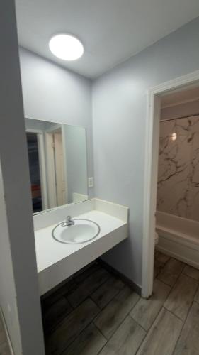 a bathroom with a sink and a mirror at Ada Inn & Suites in Ada