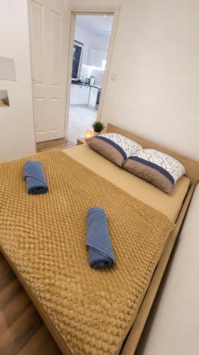two pillows on a bed in a room at Ametystowa Street in Września