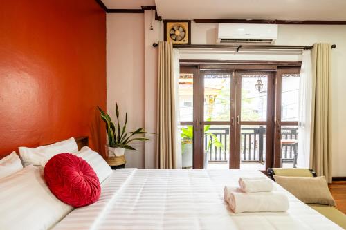 a bedroom with a large bed with a red ball on it at BlueHome Apartment in Vientiane