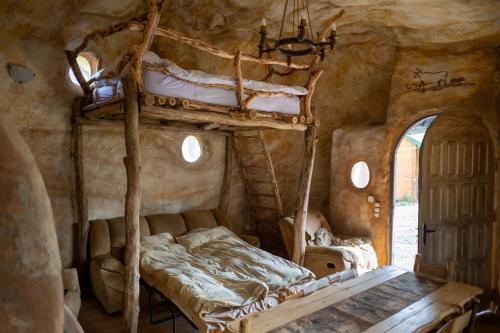 a bedroom with two bunk beds in a cave at Midgard in Osiecznica