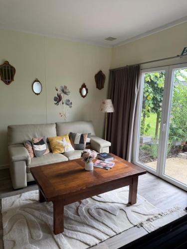 a living room with a couch and a coffee table at B&B Bombon in Herk-de-Stad