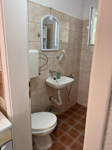 a bathroom with a toilet and a sink at gvero apartments in Prilep