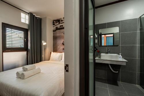 a hotel room with a bed and a sink at BlueHome Apartment in Vientiane