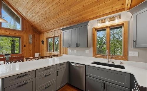 a kitchen with white counter tops and wooden ceilings at Lake Bear Lair in McHenry