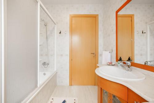 a bathroom with a sink and a shower and a tub at Casa ELPI in Guardiola