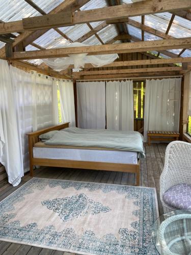 a bedroom with a bed and a wooden ceiling at Lappnäs Bed & Breakfast in Sunne
