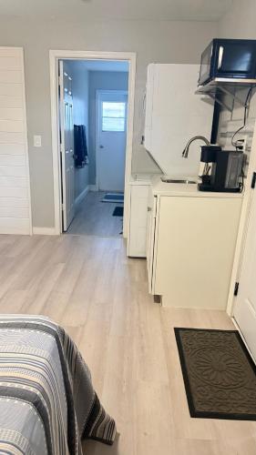 a room with a kitchen with a sink and a counter at Studio one bed in Clermont