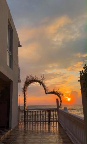 a heart shaped arch with the sunset in the background at Mari House in Buknari