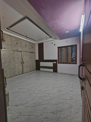 an empty room with a large room with a large floor at The Green stays in Madurai