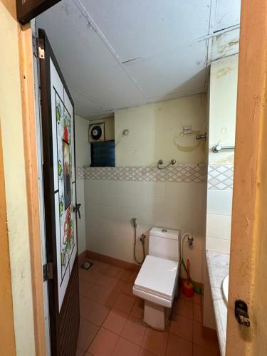 a small bathroom with a toilet and a sink at ChriSeph in Kottayam