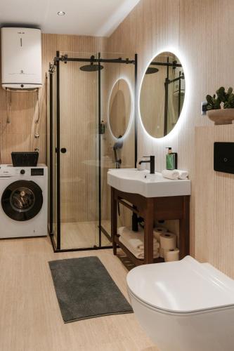 a bathroom with a shower and a sink and a toilet at One bedroom Belane Rezident in Tivat