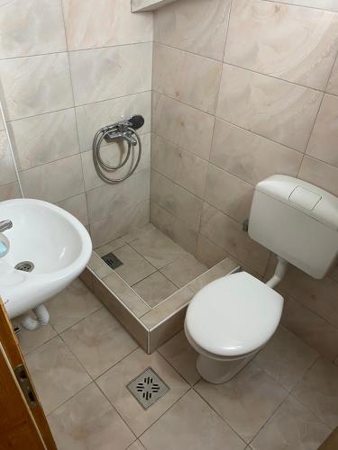 a bathroom with a toilet and a sink at Mia in Glavatske Kućice