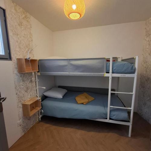 a bedroom with two bunk beds in a room at La Vie Est Belle in Salles-la-Source