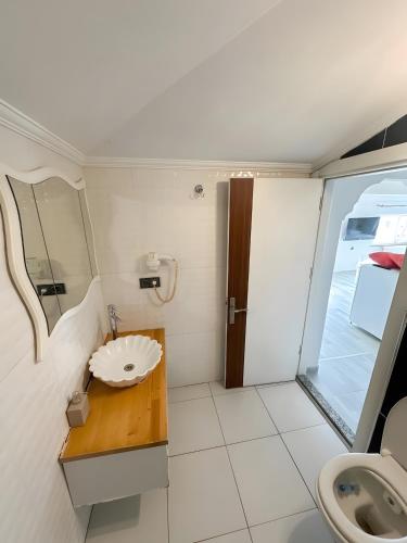 a small bathroom with a sink and a toilet at Air Otel in Trabzon